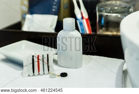 Hotel Sewing Kit And Hand Cream In Hotel Bathroom. Small Portable Thread Repair Emergency Kit With N
