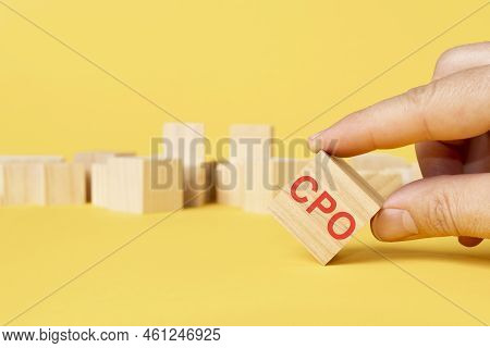 Man Hand Chosen Wooden Block With Text Cpo On Yellow Background