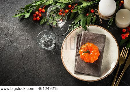 Autumn Table Setting With Plate, Cutlery, Pumpkin And Candles. Thanksgiving Food Festive Dinner Conc