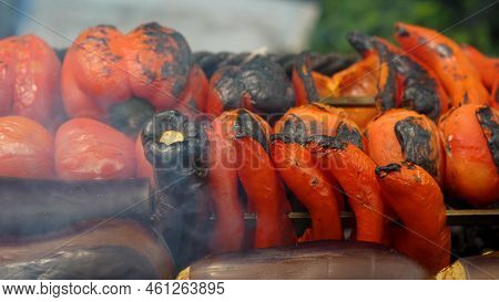 Red Peppers, Tomatoes, Sweet Peppers And Eggplants Are Cooked On Coals On The Grill. Vegetables With