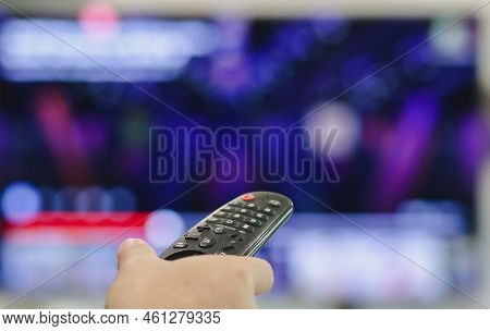 Close-up Of Hand With The Remote Control Television And Presses The Button. Television Remote Contro