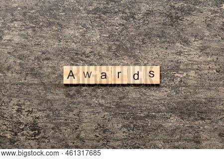 Awards Word Written On Wood Block. Awards Text On Cement Table For Your Desing, Concept.