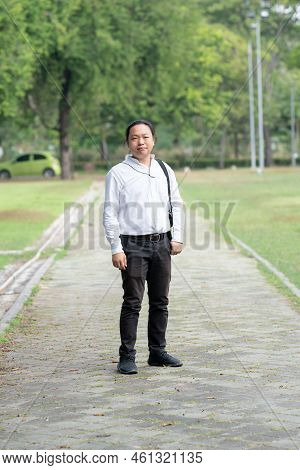 Asian Freelance Long Hair Man Standing And Posting On The Walk Way In The Garden Outdoor Field With 