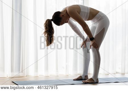 Young Fitness Woman Practicing Nauli Yoga Breathing