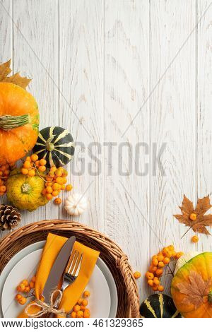 Thanksgiving Day Concept. Top View Vertical Photo Of Rattan Basket With Plate Knife Fork Napkin Pump