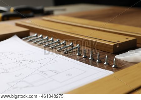 Composition With Furniture Parts And Tools For Self-assembly On Wooden Background, Closeup