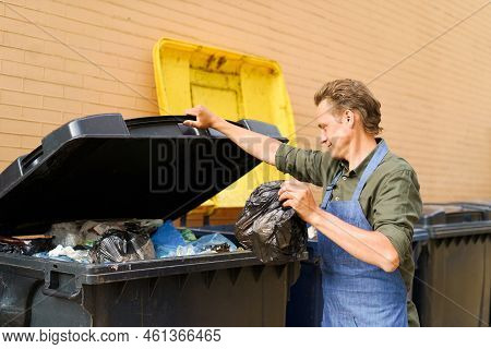 Caucasian Handsome Man Employee Open Can Full Of Garbage To Throw Plastic Bag With Trash Wearing Apr