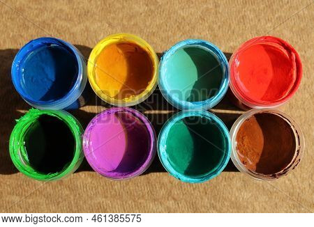Acrylic Paints In Jars. Top View Photo Of Opened Pots With Different Colors Of Paint