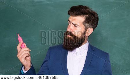 Thinking Man. Teacher Or Professor Near Blackboard. Thinking Serious Mature Teacher. Mature Professo