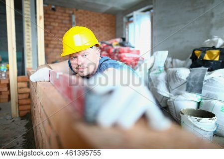 Builder Carefully Places Red Brick On Masonry. Bricklayer Work Masonry Construction Wall Concept