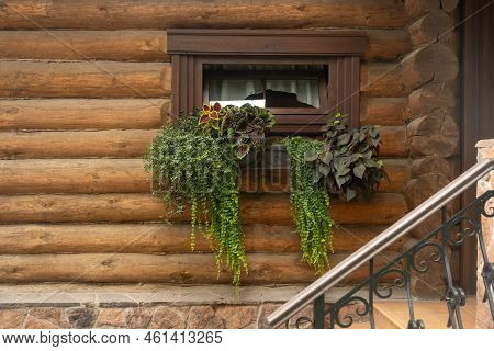 Beautifully Decorated Window In A Wooden House. A Small Window Is Decorated On The Outside With A Sm
