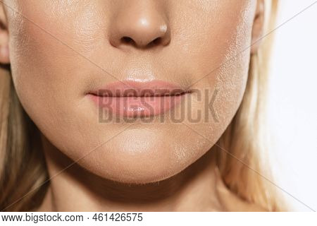 Closeup Of Female Lips, Cheeks And Nose Isolated Over White Studio Background. Concept Of Cosmetolog