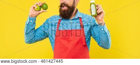 Man Crop View In Apron Holding Lime And Juice Bottle Yellow Background, Juicery