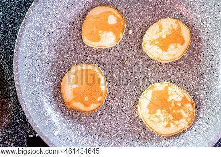 Frying Small Pancakes On A Kefir Base In A Frying Pan.
