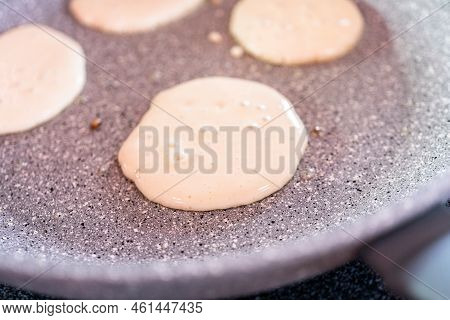 Frying Small Pancakes On A Kefir Base In A Frying Pan.