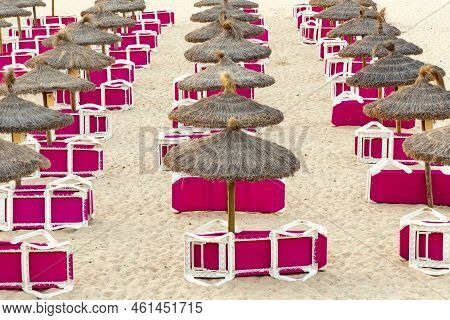 Red Beach Couch Ain The Morning At The Sandy Beach With Straw Parasols Waiting For First Tourists In