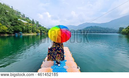 Young Woman Standing On Plastic Pier With The Stunning View Of Mountains Fog, Clouds And Trees Over 
