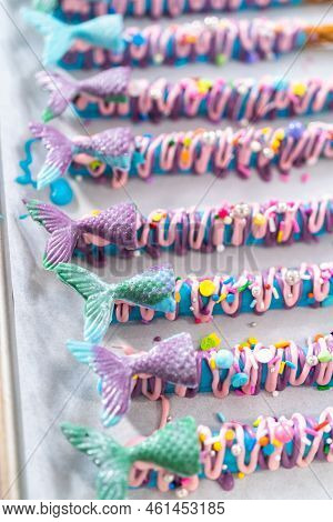 Mermaid Chocolate Pretzel Rods Drizzled With Pink And Purple Chocolate And Covered With Sprinkles.