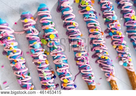 Mermaid Chocolate Pretzel Rods Drizzled With Pink And Purple Chocolate And Covered With Sprinkles.