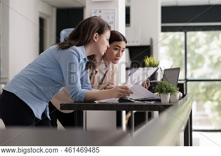 Start Up Company Employees Discussing Financial Report, Comparing Research Statistics On Documets An