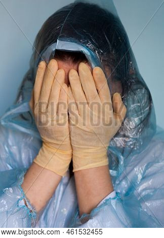 Woman In A Protective Suit Closing Her Face. Distressed Woman. Coronavirus (covid-19) Disease Outbre