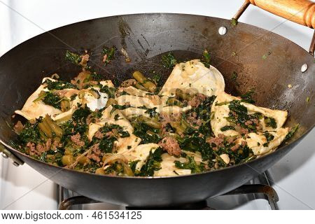 Perogies With Ground Beef, Spinach, And Sting Beans Cooked In A Wok.