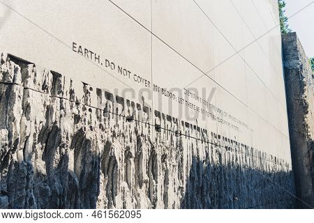 08.27.2022 - Belzec, Poland - Belzec Nazi Death Camp. Concrete Wall With Polish And English Writing 