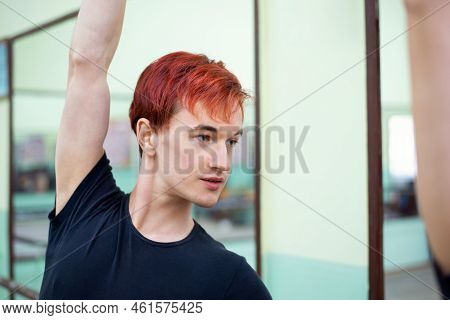 Portrait Of A Male Dancer Learning To Dance Near The Mirror. Young Man In Black Clothes At The Lesso