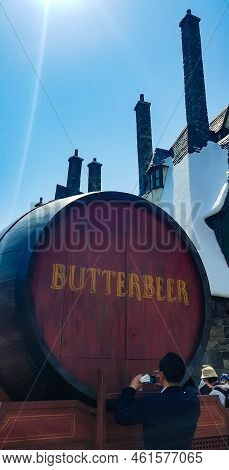 Osaka, Japan On April 10, 2022. A Man Is Standing In Front Of A Barrel Of Butterbeer. This Drink Is 