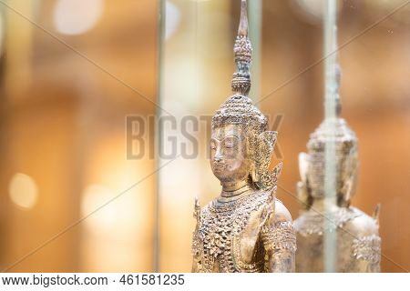 Deity Statue Standing Straight Made Of Brass, Wearing Gold Costume With Chada On Top Of His Head In