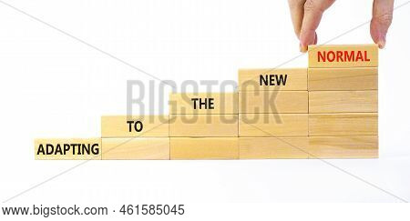 Adapting To The New Normal Symbol. Wooden Blocks With Words Adapting To The New Normal On Beautiful 