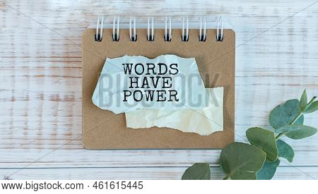 Words Have Power Text In Torn Booge On A Notepad On A Wooden Background With A Twig Of Eucalyptus.