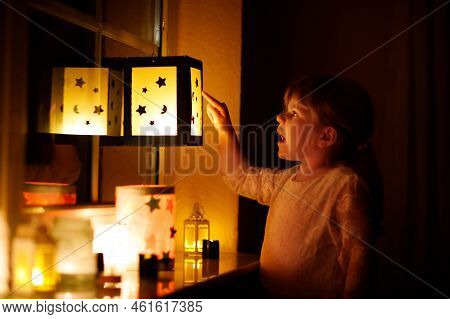 Little Kid Girl Sitting By Window With Selfmade Hand Crafted Lanterns With Candles For St. Martin Pr