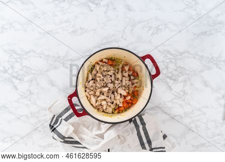 Flat Lay. Cooking Chicken Noodle Soup With Kluski Noodles In An Enameled Dutch Oven.