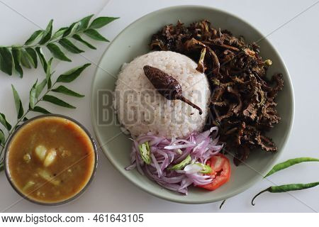 White Rice Meal Along With Fried Bitter Gourd And Onion Tomato Salad Called Challas Served With Samb