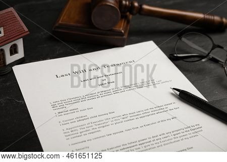 Last Will And Testament Near House Model, Glasses, Gavel On Black Table, Closeup
