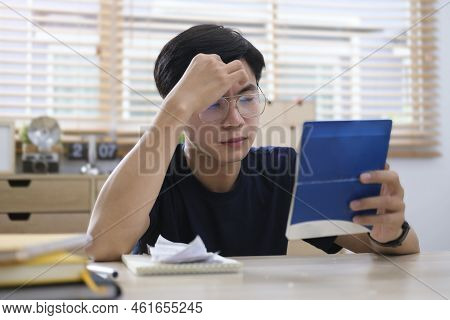 Worried Asian Man Calculating Bills, Upset About Money Problem, Manage Household Finances At Home.
