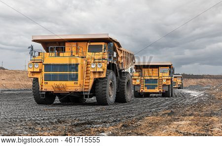 Large Quarry Dump Truck. Big Yellow Mining Truck At Work Site. Loading Coal Into Body Truck. Product