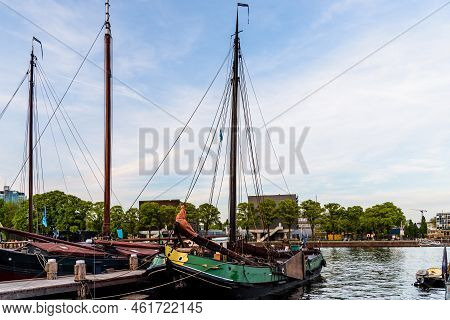 Amsterdam, Netherlands - May 6, 2022: Old Wooden Vessels Moored In The Society Museum Harbor Amsterd