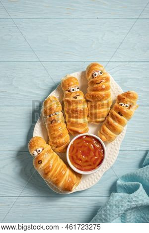 Fun Food For Kids. Mummy Sausages Scary Halloween Party Food Decoration Wrapped In Dough With A Bowl