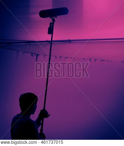 Sound Boom Operator Recording Sound By Microphone Fisher For Movie Set In A Studio.