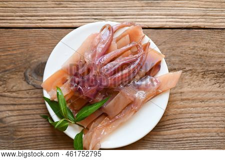Raw Squid For Cooking Food On Wooden Table, Preserving Food Seafood, Pickled Squid On White Plate - 