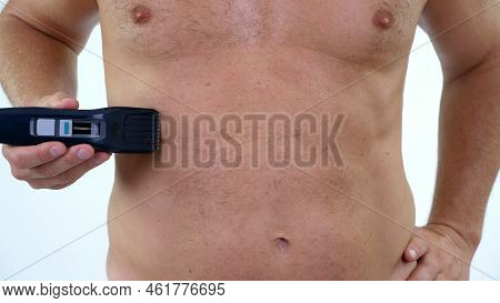 Close-up Of A Very Hairy Man Haircut Body Hair On His, Male Chest By Himself With A Clipper, Electri