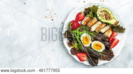 Keto Breakfast Two Eggs, Avocado, Strawberry, Grilled Chicken Fillet, Nuts And Fresh Salad, Ketogeni