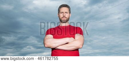 Grizzled Man Sky Background. Serious Man Grizzle Keeping Arms Crossed. Confident Man In Casual