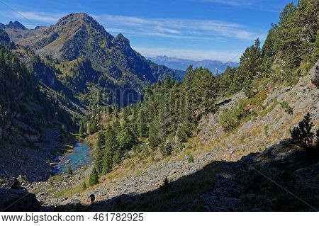 Landscape Of Forests And Mounts Around Leama Lake With A Hiker Silhouette