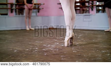 Close Up, In Ballet Class, On An Old Wooden Floor, Ballerina Performs Glissade En Tournant, She Movi