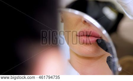 Medical Office, Beautiful Woman Looking In The Mirror, Doctor Probes The Patients Lips After Injecti