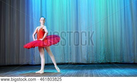 Ballet Rehearsal, On The Stage Of The Old Theater Hall. Young Ballerina In Red Ballet Tutu And Point