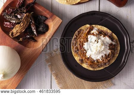 Tostada De Tinga De Res. Typical Mexican Dish Prepared Mainly With Shredded Beef, Onion And Dried Ch